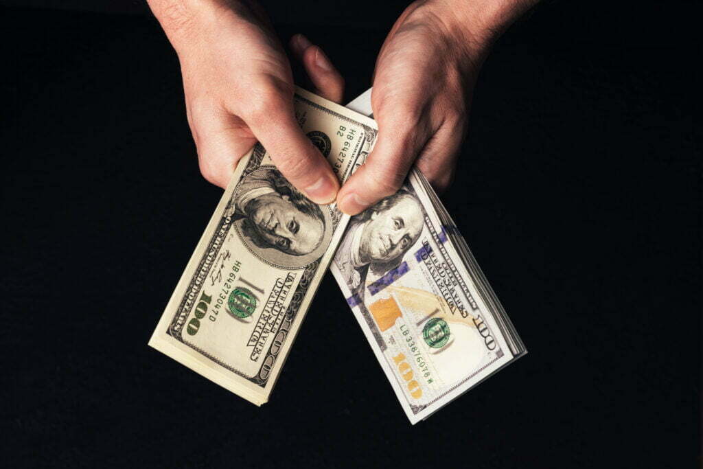 male hands holding us hundred dollars banknotes 2022 09 30 03 16 09 utc