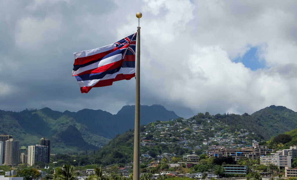 hawaiian flag with mountains and city in backgroun 2022 10 07 19 51 11 utc